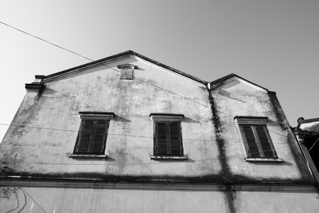 Old house with windows in Hoi An ancient town, Vietnam. Black and White tone.の写真素材