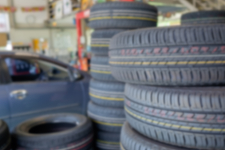 Blurred image - Stack of old tires in a car shop garage. Tire installation service.の写真素材