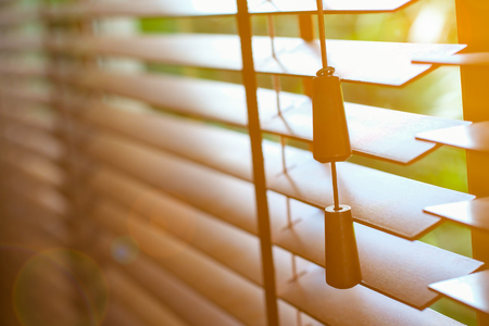 Wooden blinds with sun light and lens flare effect.の写真素材