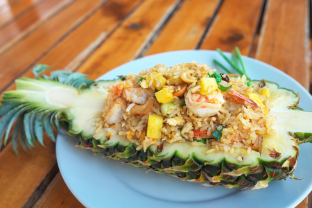 Pineapple Fried rice with seafood served in a pineapple.の写真素材