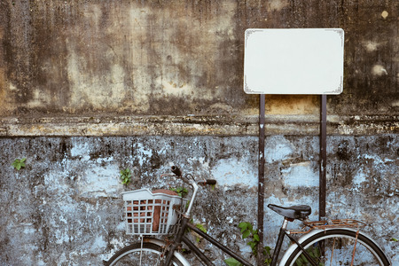 Old bicycle against old wall on a street of Hanoi old town, Vietnam.の写真素材