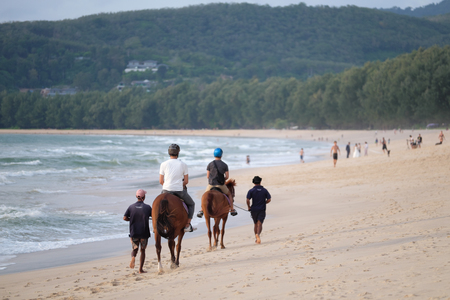 PHUKET, THAILAND - OCTOBER 21, 2017:  Tourists riding horses on the beach in Phuket Island, Thailand.のeditorial素材