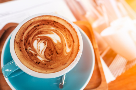 Late art coffee with heart shape on wood table background. Top view.の写真素材
