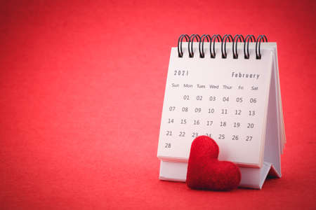 February Calendar 2021 page and red heart on red background , Valentine's Day Concept.の写真素材