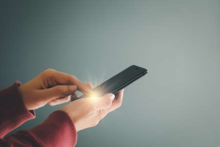 Woman using mobile smartphone for Internet connection, social media, online shopping, social networking, Point finger on screen mobile phone closeup.の写真素材