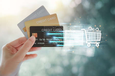 Woman hand holding various credit cards to pay for shopping. Online shopping payment by credit card...