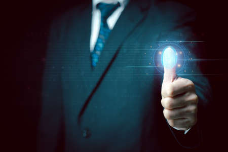 Businessman scans his fingerprint to access personal financial data. Futuristic business technology security concept. Innovation technology against digital cybercrime. Biometrics identity.の写真素材