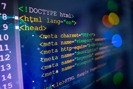 HTML code on computer monitor and server room background.