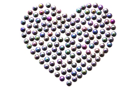 Shiny glass beads in the shape of a heart isolated on whiteの写真素材
