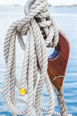 A wooden deadeye with rope on a sailing vesselの写真素材