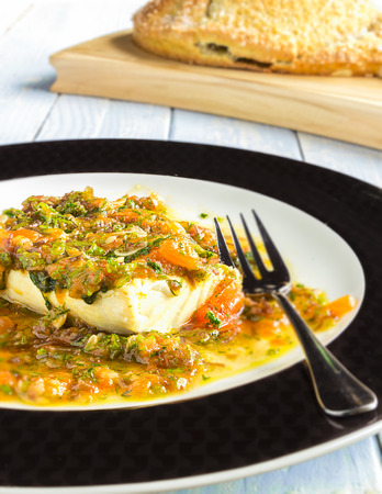 Opakapaka, commonly known as Hawaiian pink snapper, baked inside a salted bread crust and topped with tomato ogo sauceの写真素材
