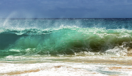 A wave breaking on the shore of Sandy Beach on Oahu, Hawaii