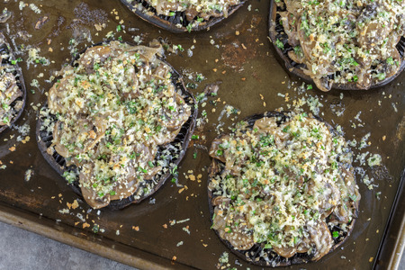 Portobello mushroom caps filled with shallots and cremini mushroom in a white wine cream sauce, broiled with a parmesan, chive and cilantro panko toppingの写真素材