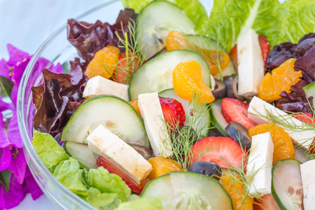 Tropical summer salad of fruits and vegetables with tofu and feta cheeseの写真素材