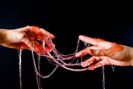 Hands stretch wax to depilation on a black background close-upの写真素材