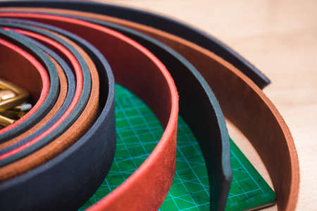 Leather blanks for red, black and red belts close-up