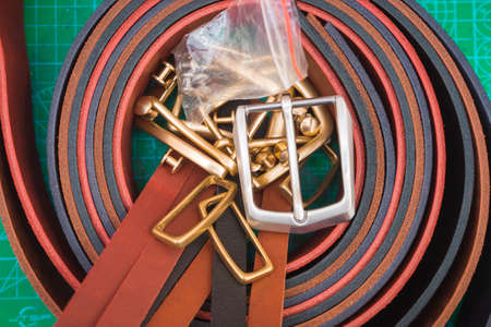 Leather straps lying on a green stand on the table