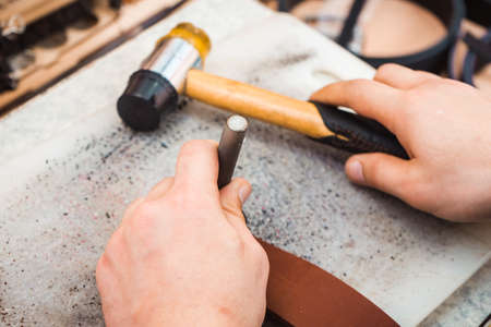 A tool for making holes in the skin in the hands of the master. Hammer in hand