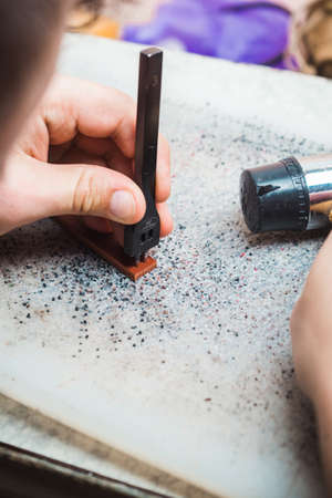 A tool for making holes in the skin in the hands of the master. Hammer in hand