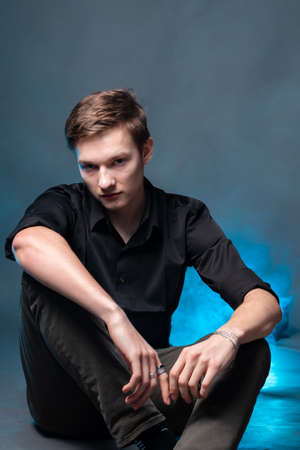 Portrait of a gay man on a gray backgroundの写真素材