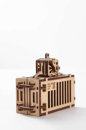 Toy wooden port container with motorcycle inside