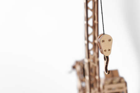 Toy loop of a draw crane made of wood on a white backgroundの写真素材
