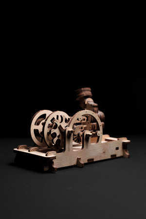 Model engine made of wood and plywood on a black backgroundの写真素材