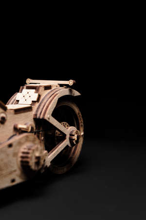 Wooden toy-motorcycle designer on a black backgroundの写真素材