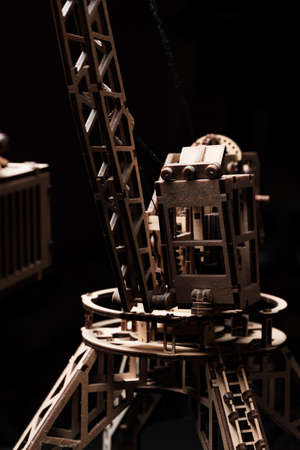 Wooden gears of the mechanism close-up on a black background