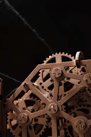 Wooden gears of the mechanism close-up on a black background