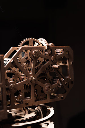 Wooden gears of the mechanism close-up on a black backgroundの写真素材