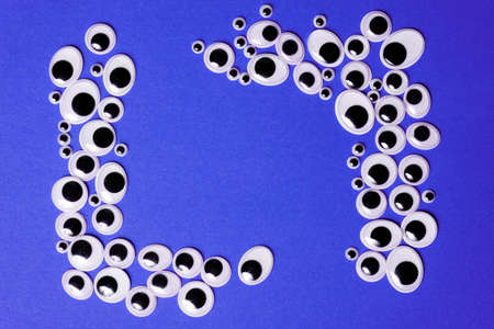 Frames for text from toy eyes on monochrome purple background