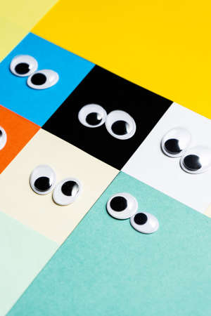 Smileys from toy eyes on hermetic multi-colored backgroundの写真素材