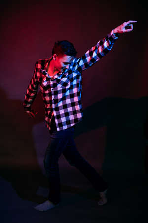 Dancing guy with red and blue lightの写真素材