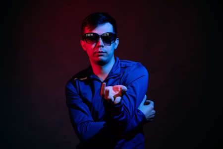 A young man illuminated by bright and rich colorsの写真素材