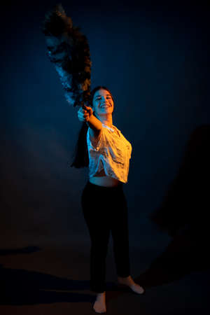 Girl in a shirt with pipidustre illuminated by complementary lightの写真素材
