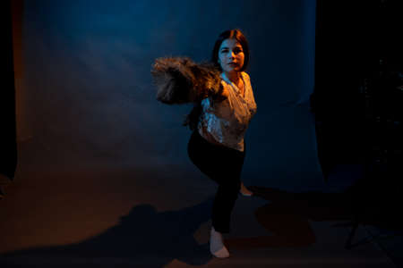 Girl in a shirt with pipidustre illuminated by complementary lightの写真素材
