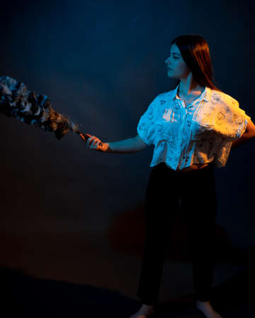 Girl in a shirt with pipidustre illuminated by complementary lightの写真素材