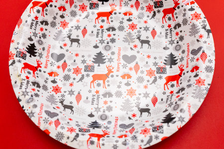Christmas plate with reindeer and snowflakes on red backgroundの写真素材