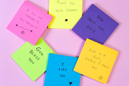 Colorful sticky notes on a pink background with the words of loveの写真素材