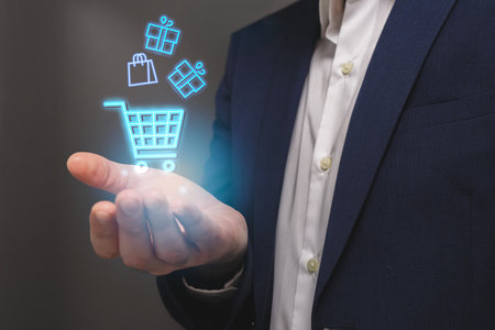 Businessman with shopping cart icon in his hand. Online shopping conceptの写真素材