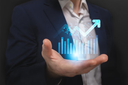 Businessman holding hologram of growing graph in his hand. Financial growth conceptの写真素材