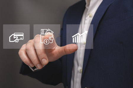 Businessman pressing business type of modern buttons on a virtual background.の写真素材