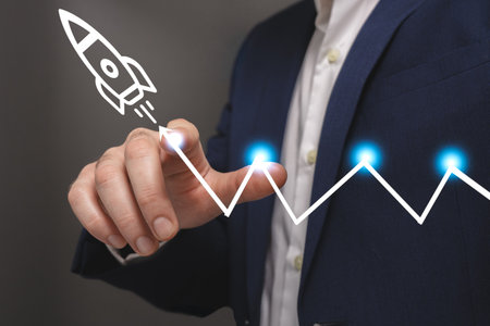 Businessman drawing rocket on virtual screen, closeup. Start up conceptの写真素材