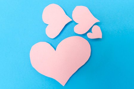 4 pink hearts on a blue background. Valentine's Day conceptの写真素材