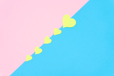 group of yellow hearts on a pink and blue background, valentine background . Valentine conceptの写真素材