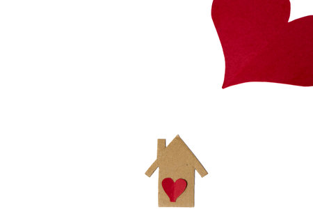 Wooden house with red heart on white background with copy space.の写真素材