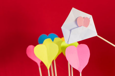 Valentine's day background with red paper hearts on blue and pink backgroundの写真素材