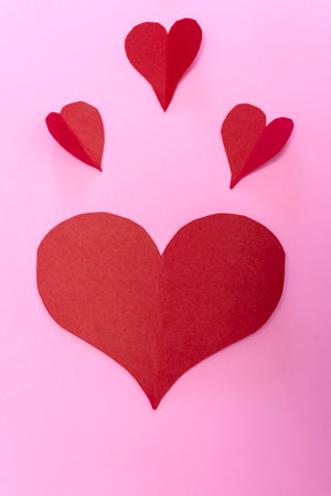 Red paper hearts on a pink background. Valentines Day background.の写真素材