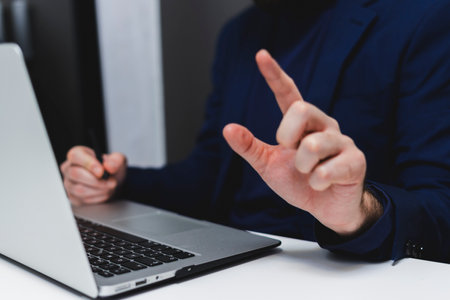 Close-up of a businessman using a laptop in the office.の写真素材